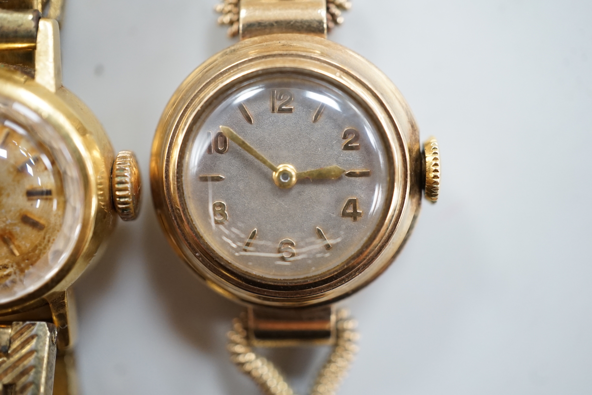 A lady's 9ct gold Omega manual wind wrist watch, on a gold plated bracelet, together with a lady's 9ct gold manual wind wrist watch, on a 9ct gold bracelet.